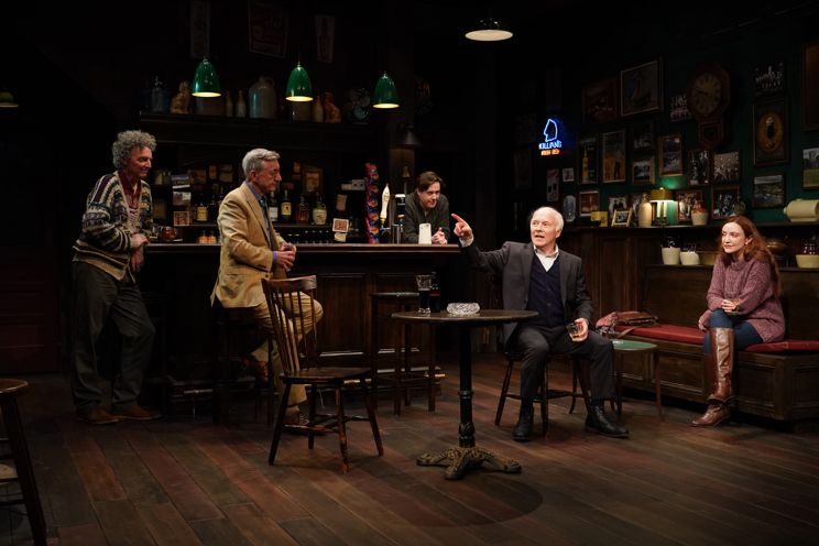 Five people sitting in a dark bar