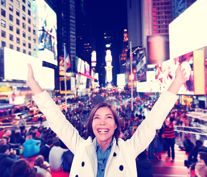 Women in Times Square with her arms outstretched