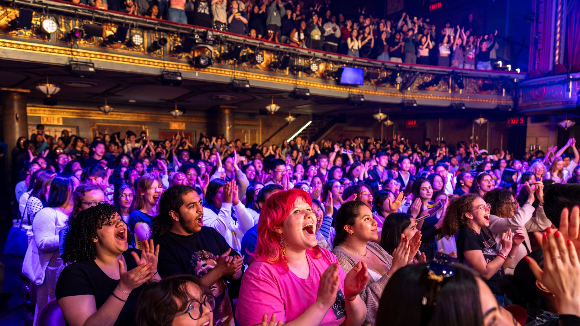 A group of applauding audience members